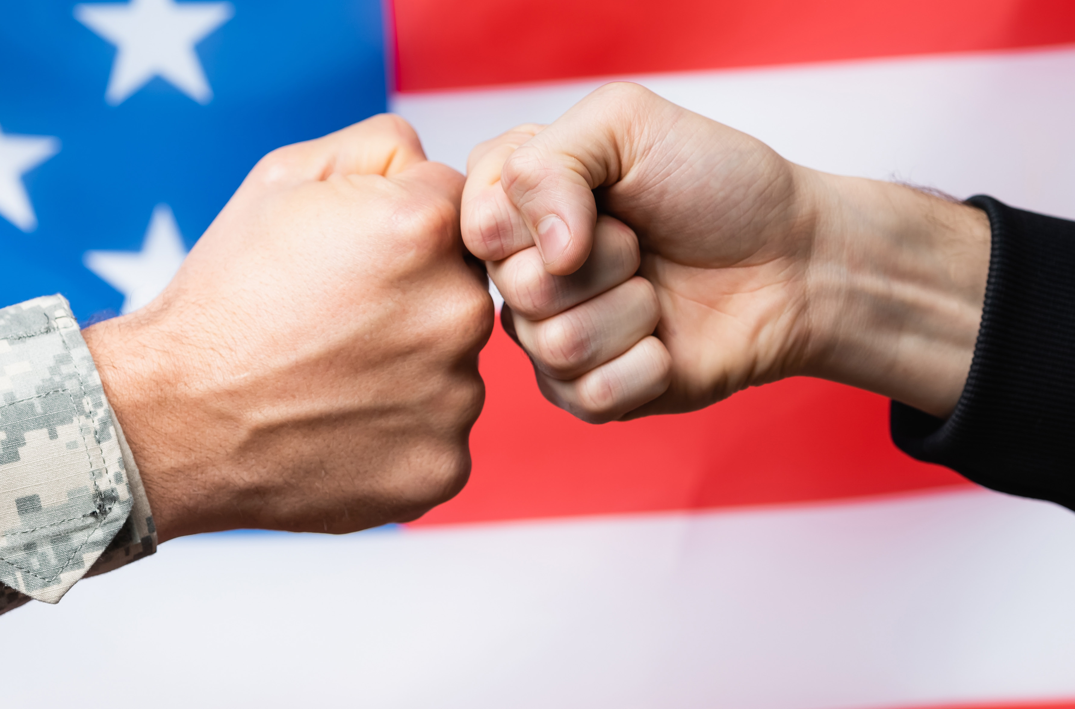 Pro American Fist-Bump between a Veteran and Imagine! with American Flag Background