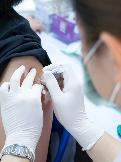 A vaccine shot is administered into someones arm